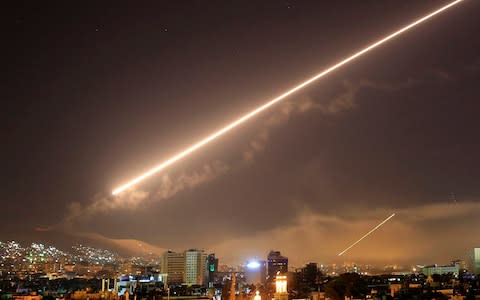 Damascus skies erupt with service to air missile fire as the U.S. launches an attack on Syria - Credit: AP