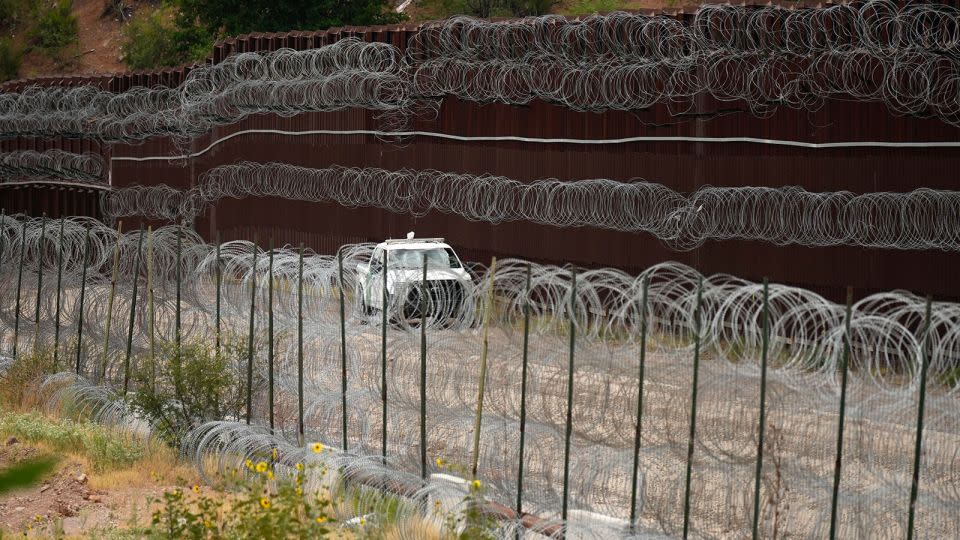 A vehicle drives along the U.S. side of the US-Mexico border wall in Nogales, Ariz. on Tuesday, June 25, 2024. - Jae C. Hong/Pool/AP