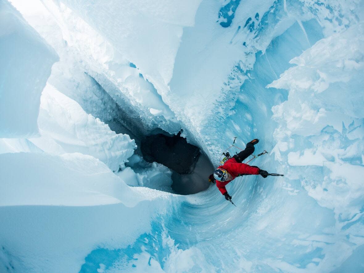 Ice climber Will Gadd, shown in a handout photo, rappelled into the bowels of Greenland's ice cap. Gadd is familiar with the risks of his sport but also wary of the new unpredictability climate change is bringing to mountain adventure.  (The Canadian Press/Handout - Christian Pondella - image credit)