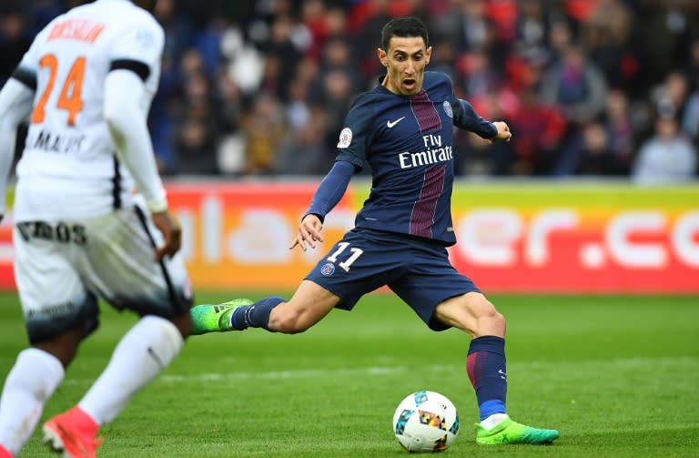 Paris Saint-Germain's Angel Di Maria (R) shoots during their match against Montpellier at the Parc des Princes stadium in Paris on April 22, 2017