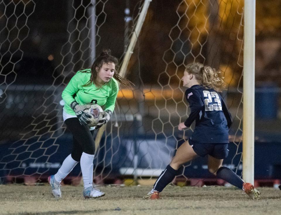 Golden Eagles goalkeeper Micayla Mansberger (0) makes the save as Ava Matherne (23) makes on run on goal during the Naples vs Gulf Breeze girls 5A State Semifinal soccer match at Gulf Breeze High School in Gulf Breeze, Florida on Friday, Feb. 18, 2022.