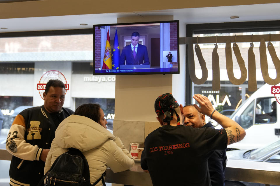 Customers have breakfast in a restaurant while Spanish Prime Minister Pedro Sanchez appears on a television broadcast in Madrid, Spain, Monday, April 29, 2024. Sánchez says he will continue in office "even with more strength" after days of reflection. Sánchez shocked the country last week when he said he was taking five days off to think about his future after a court opened preliminary proceedings against his wife on corruption allegations. (AP Photo/Paul White)