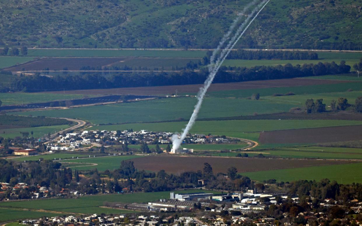 This picture taken in northern Israel shows Israel's Iron Dome missile defense system intercepting rockets being fired from Lebanon