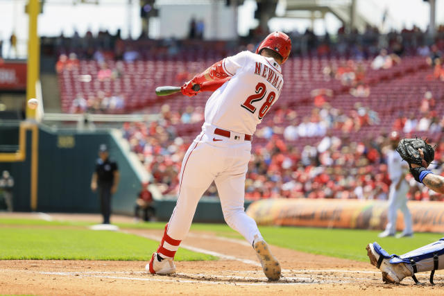 Cincinnati Reds' Kevin Newman hits a two-run single during the first inning of a baseball game against the New York Mets in Cincinnati, Thursday, May 11, 2023. (AP Photo/Aaron Doster)