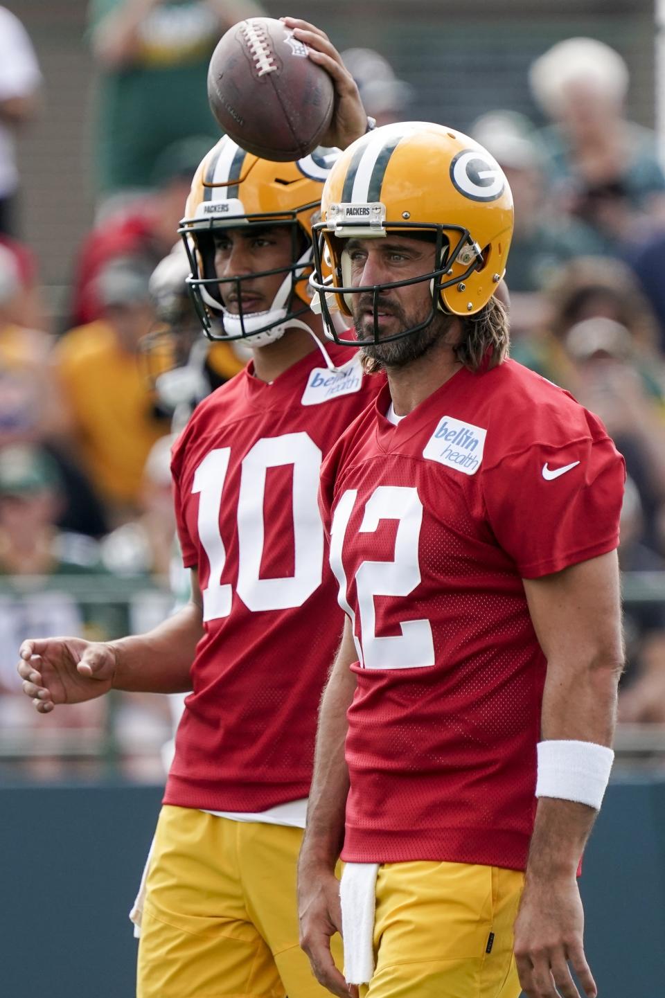 Green Bay Packers' Aaron Rodgers and Jordan Love run a drill at the NFL football team's practice field Wednesday, July 27, 2022, in Green Bay, Wis. (AP Photo/Morry Gash)