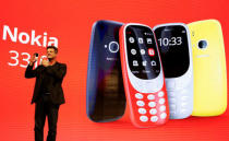 Arto Nummela, CEO of Nokia-HMD, holds up a Nokia 3310 device during a presentation ceremony at Mobile World Congress in Barcelona, Spain, February 26, 2017. REUTERS/Paul Hanna