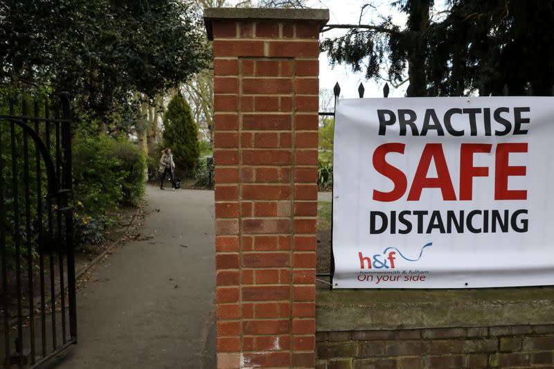 A sign is shown warning people to practise safe distancing