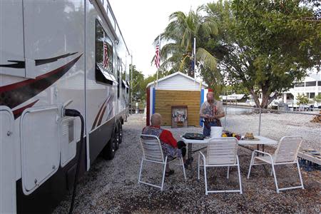 Huie Gordon, a retired Monroe County Sheriff's Deputy and neighbor of Doug Varrieur (R) prepare to practice their firing stances with unloaded weapons in the yard of Varrieur's home in Big Pine Keys in the Florida Keys March 5, 2014. REUTERS/Andrew Innerarity