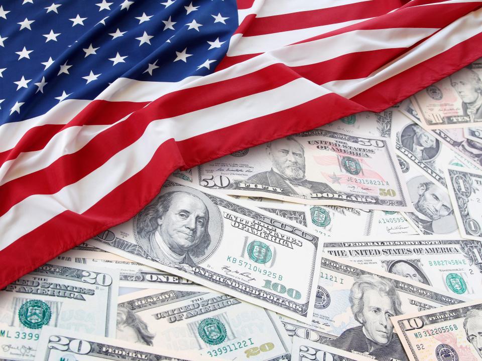 American flag over US money