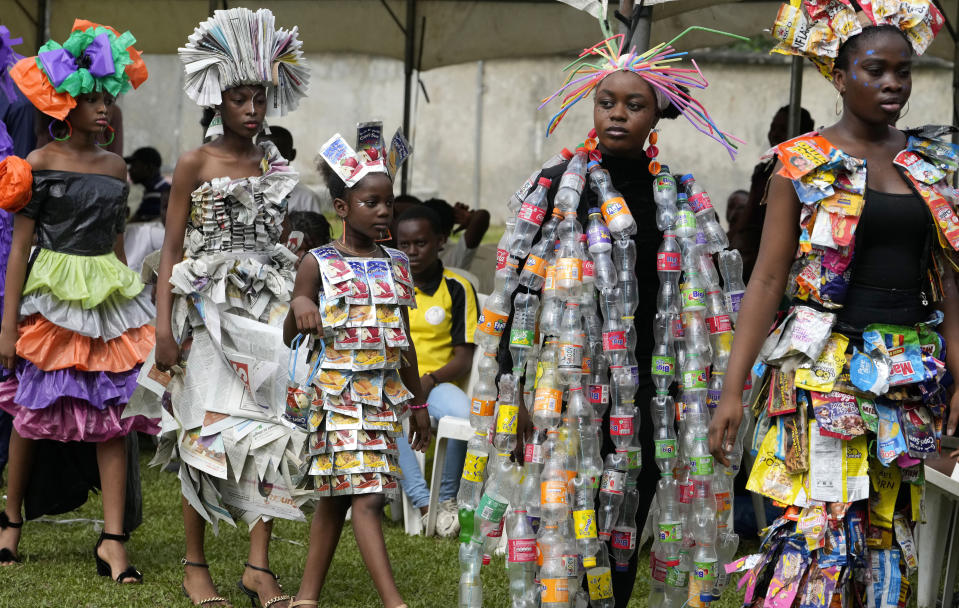 Models, wearing outfits made from various recycled materials, walk around the venue of the 'trashion show' in Sangotedo Lagos, Nigeria, Saturday, Nov. 19, 2022. (AP Photo/Sunday Alamba)