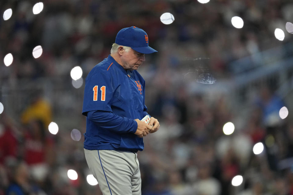 New York Mets manager Buck Showalter walks back to the dugout after making a pitching change in the fourth inning of a baseball game against the Atlanta Braves, Thursday, June 8, 2023, in Atlanta. (AP Photo/John Bazemore)