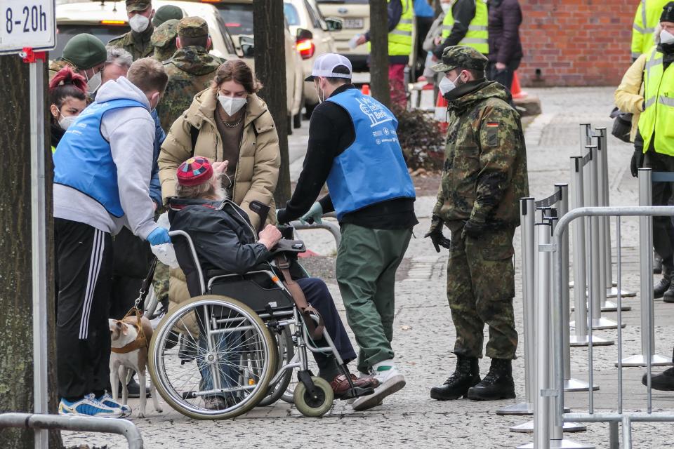 BERLIN, March 19, 2021 -- Staff members help an old man on a wheel chair enter a COVID-19 vaccination site in Berlin, capital of Germany, March 19, 2021. Germany's reported daily COVID-19 infections continued to rise sharply on Friday as the country registered 17,482 new cases in one day, the Robert Koch Institute RKI said on Friday. (Photo by Stefan Zeitz/Xinhua via Getty) (Xinhua/Stefan Zeitz via Getty Images)