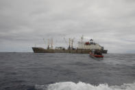 In this photo made available by the U.S. Coast Guard, guardsmen from the cutter James conduct a boarding of a fishing vessel in the eastern Pacific Ocean, on Aug. 3, 2022. During the 10-day patrol for illegal, unreported or unregulated fishing, three vessels steamed away. Another turned aggressively 90 degrees toward the James, forcing the American vessel to maneuver to avoid being rammed. (Petty Officer 3rd Class Hunter Schnabel/U.S. Coast Guard via AP)
