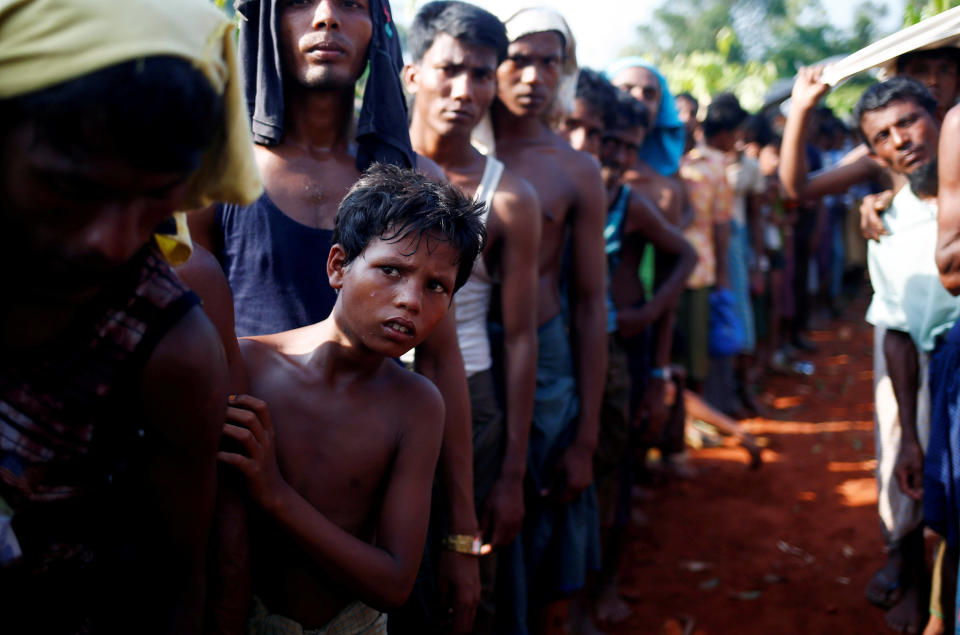 A Rohingya refugee boy stands in a queue to receive relief supplies given by local people in Cox's Bazar, Bangladesh, on Sept. 16, 2017.