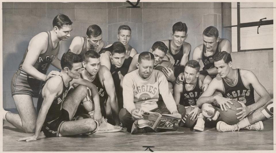 So that's the way they have us ranked?" the Oklahoma A&M basketball team seems to be saying as it looks over coach Henry Iba's shoulder at a national magazine's early-season cage survey. In the back row from the left are Gerald Stockton, John Miller, Ken Hicks, Bob Seymore and Kendall Sheets. Seated in the row back of Iba are keith Smith, Bob Pager, pete Darcey, Gale McArthur, Norm Pilgrim and Emmett McAfee.
