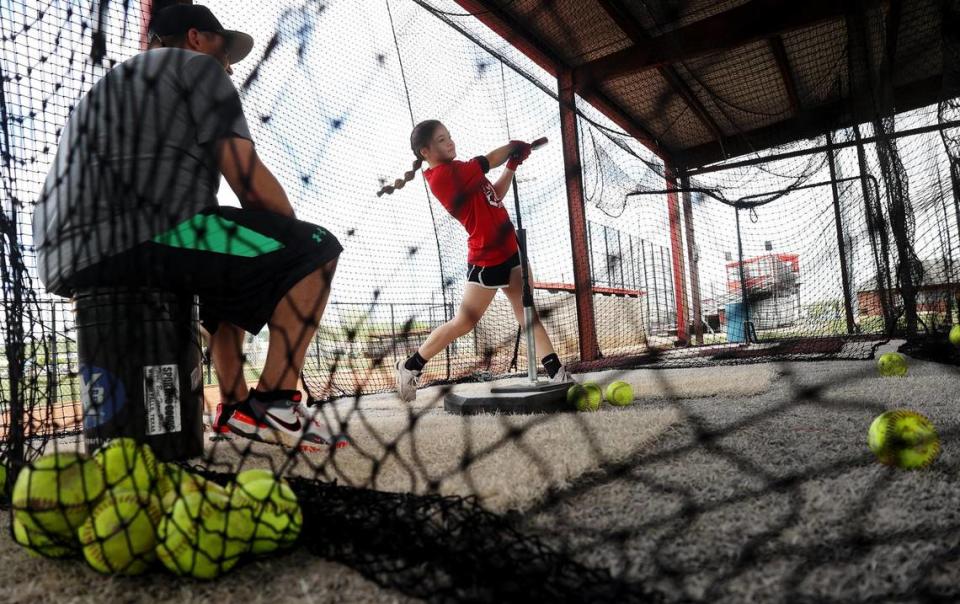 Sadie Roach practices her swing in the batting cages at Mineral Wells High School on Friday, April 14, 2023. Roach says having a four-day school week allows her more time to focus on extracurricular activities and catch up on homework.