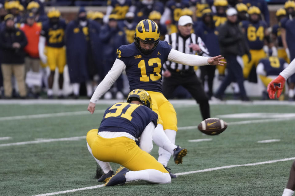 Michigan place kicker Jake Moody (13) kicks a 35-yard field goal against Illinois in the second half of an NCAA college football game in Ann Arbor, Mich., Saturday, Nov. 19, 2022. Michigan won 19-17. (AP Photo/Paul Sancya)