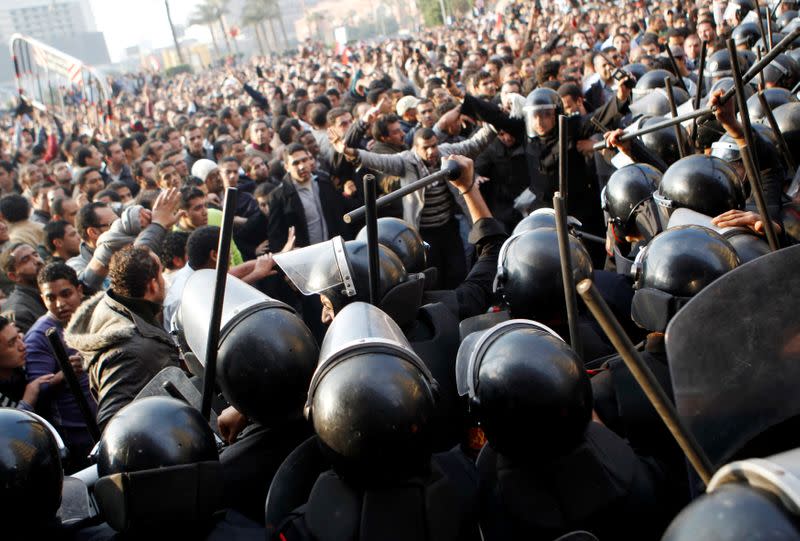 FILE PHOTO: Anti-government protesters demonstrate near riot police at Tahrir Square in downtown Cairo