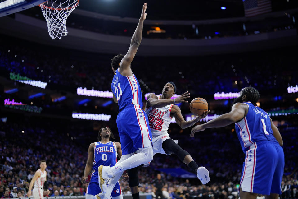 Miami Heat's Jimmy Butler (22) goes up for a shot against Philadelphia 76ers' Joel Embiid (21) during the second half of an NBA basketball game, Monday, Feb. 27, 2023, in Philadelphia. (AP Photo/Matt Slocum)