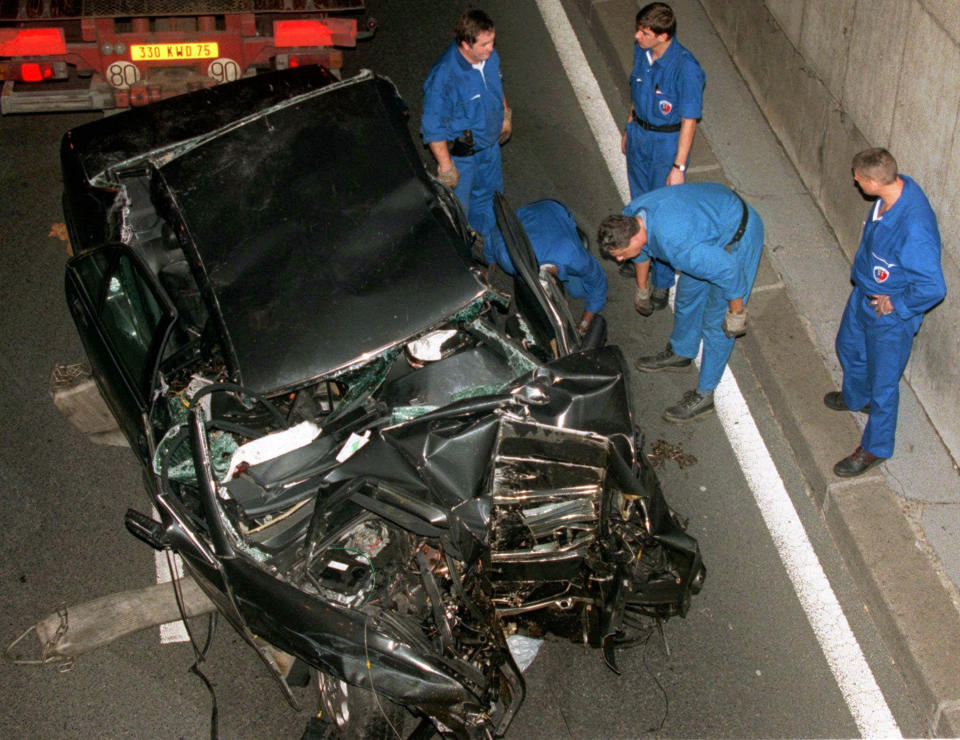 FILE - Police services in the Pont d'Alma tunnel in Paris, prepare to take away the damaged car in which Diana, Princess of Wales, and Dodi Fayed were traveling, Aug. 31, 1997. The story of Princess Diana's death at age 36 in that catastrophic crash in a Paris traffic tunnel continues to shock, even a quarter-century later. (AP Photo/Jerome Delay, File)