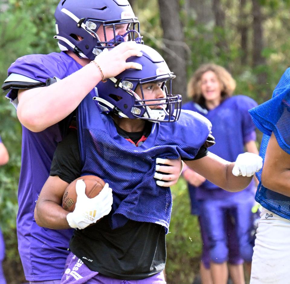 Martha's Vineyard running back Emmanuel Olivera celebrates with a teammate after scoring a touchdown in a scrimmage Tuesday against Upper Cape Tech in Mashpee.