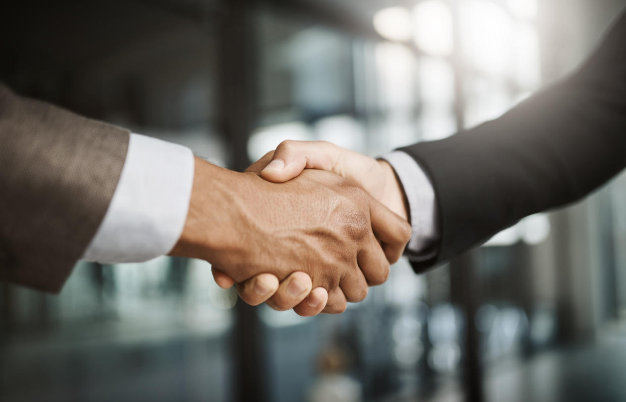 Cropped shot of two unrecognizable businessmen shaking hands in a modern office