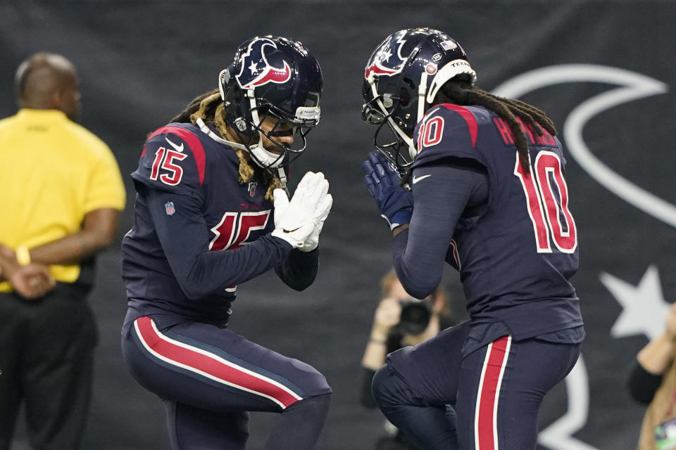 Houston Texans wide receiver DeAndre Hopkins (10) celebrates his touchdown catch against the Indianapolis Colts with teammate Will Fuller (15) during the first half of an NFL football game Thursday, Nov. 21, 2019, in Houston. (AP Photo/David J. Phillip)