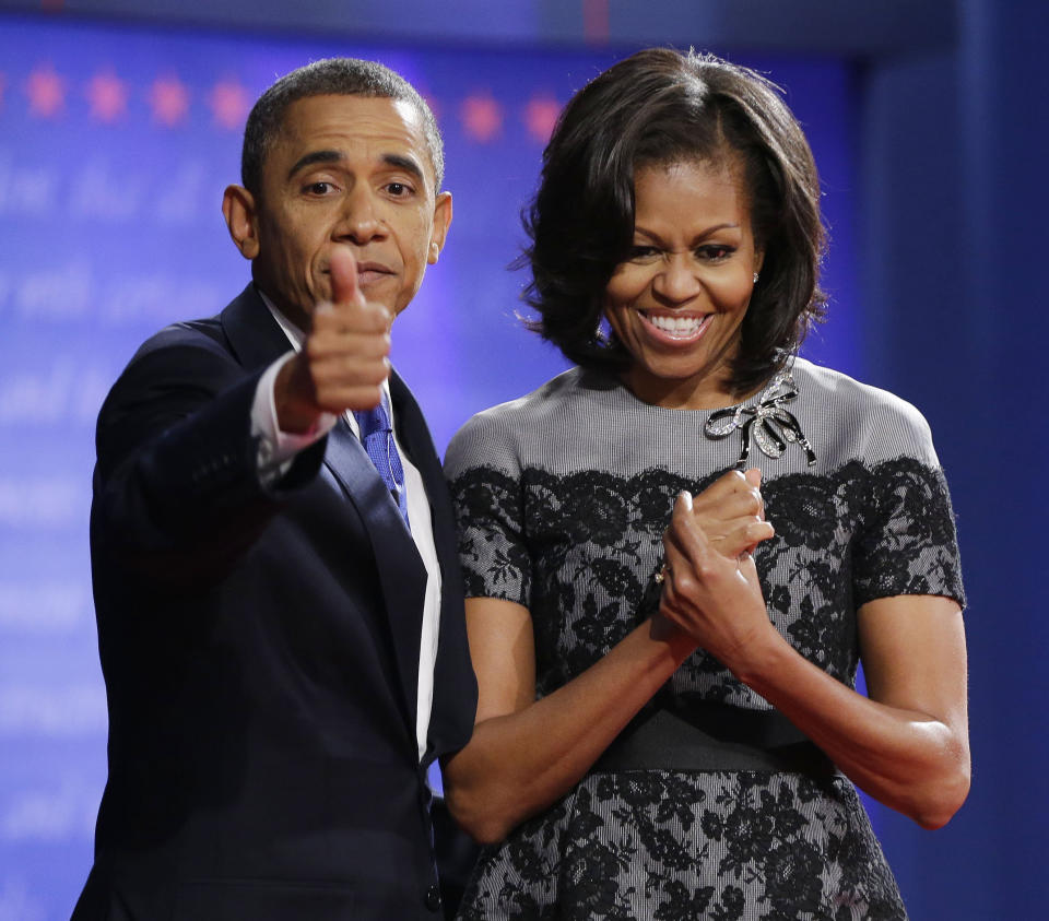 President Barack Obama, left, gives a thumbs-up as he is joined on stage by first lady Michelle Obama, right, at the end of the last debate against Republican presidential candidate, former Massachusetts Gov. Mitt Romney at Lynn University, Monday, Oct. 22, 2012, in Boca Raton, Fla. (AP Photo/Pablo Martinez Monsivais)