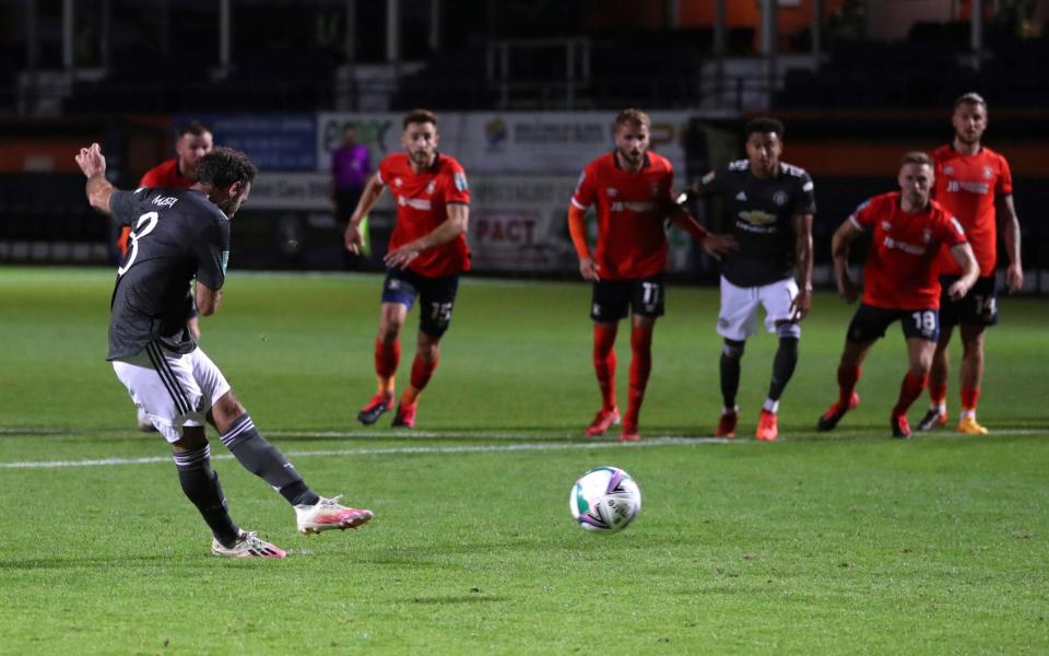 Manchester United's Juan Mata, left, scores his side's opening goal from the penalty spot during the English League Cup 3rd round soccer match between Luton Town and Manchester United - AP