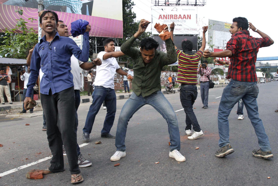 FILE - In this April 29, 2012 file photo, Bangladeshi opposition activists shout slogans before throwing stones at vehicles during a nationwide general strike against the abduction of opposition politician Elias Ali in Dhaka, Bangladesh. The abduction of Ali and his driver as they returned home from meeting supporters at a hotel on April 17, 2012, has sparked one of Bangladesh's biggest crisis in years. The clashes have reignited hostilities between Prime Minister Sheikh Hasina and her archrival Khaleda Zia, who have alternated in power since a pro-democracy movement ousted the last military regime in 1990. (AP Photo/Pavel Rahman, File)