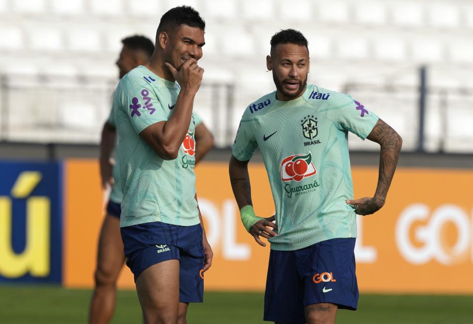 Brazil's Casemiro, left, and Neymar talk during a training session in Lima, Peru, Sunday, Sept. 10, 2023. Brazil will face Peru in a World Cup 2026 qualifying soccer match in Lima, Peru on Sept. 12. (AP Photo/Guadalupe Pardo)
