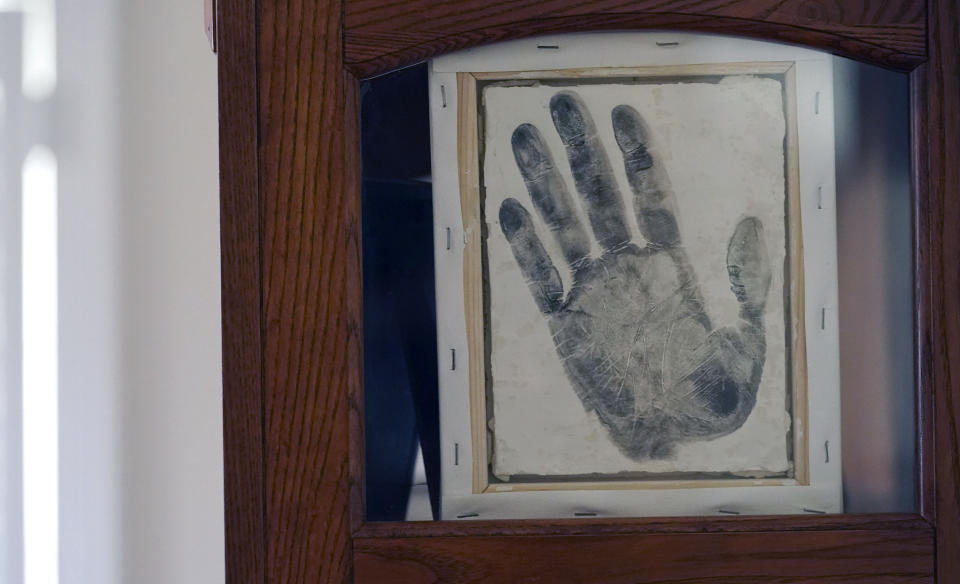 A handprint of Tyrell Wilson, who was shot and killed by a California police officer in March, is displayed at the home of his father, former U.S. Marine and retired law enforcement officer Marvin Wilson in Fort Worth, Texas, May 17, 2021. Tyrell Wilson was shot and killed by Officer Andrew Hall in the San Francisco Bay Area, just weeks before prosecutors charged the same officer with manslaughter and assault in the fatal shooting of an unarmed Filipino man more than two years earlier. Wilson's father said an emergency room nurse took the handprint of his son. (AP Photo/LM Otero)