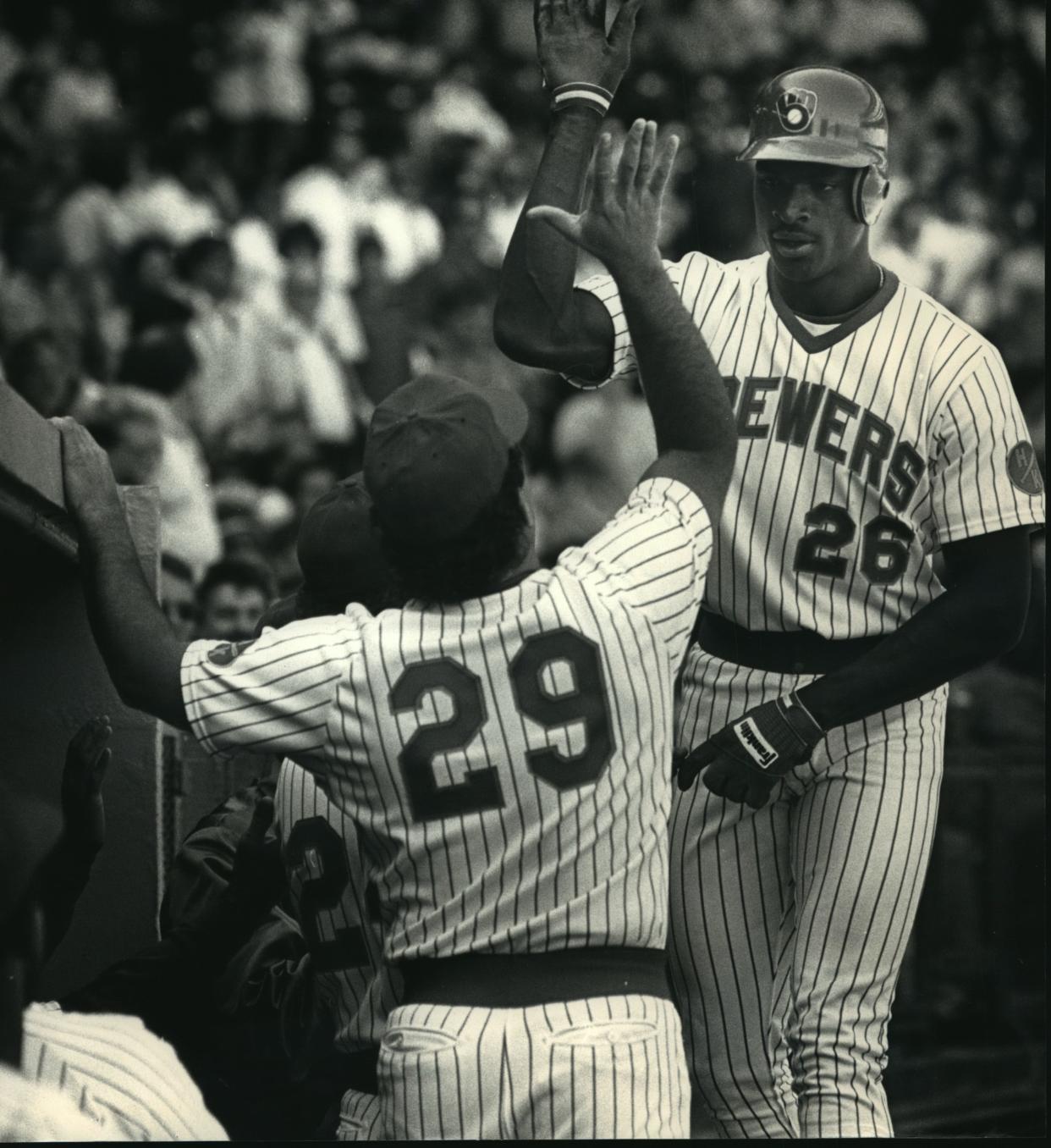 Glenn Braggs (right) receives a high five from teammate Chris Bosio following Braggs' three-run homer in 1988.