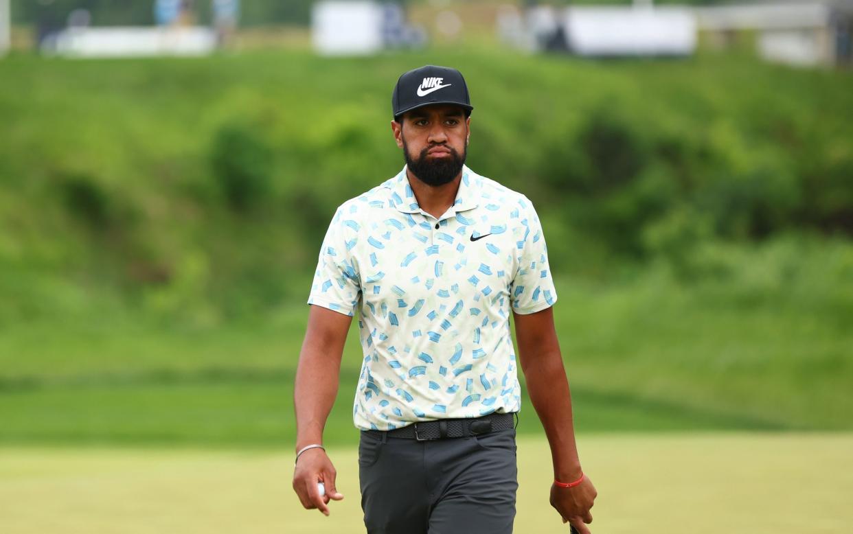 Tony Finau walks on the eighth green