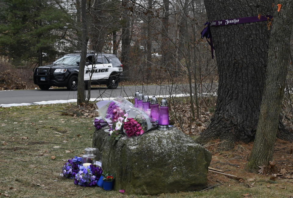 A Police vehicle is parked near a memorial for Jennifer Dulos on Tuesday, Jan. 28, 2020, in Farmington, Conn. A dispatcher from the Farmington police said officers had responded to the home of Fotis Dulos, charged with murdering his estranged and missing wife, and he was later transported to the hospital (AP Photo/Jessica Hill)