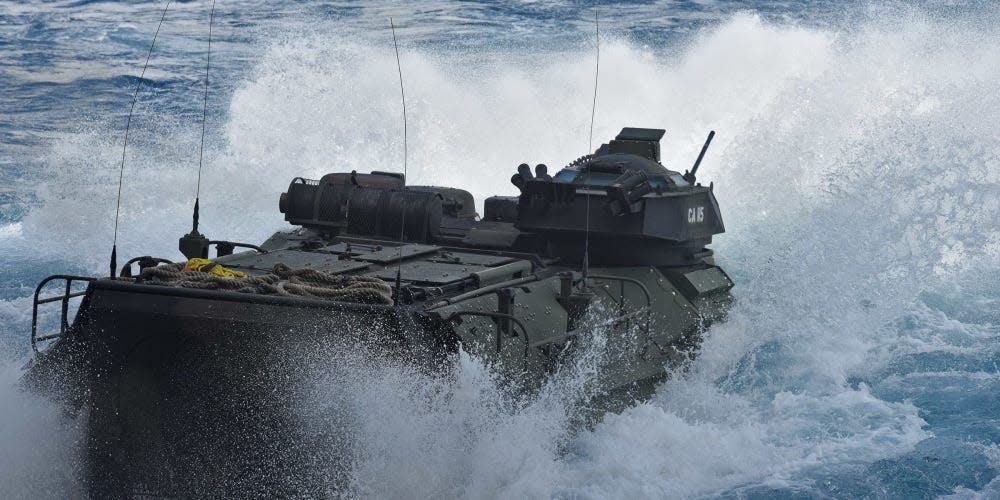 An assault amphibious vehicle departs the well deck of an amphibious transport dock ship.