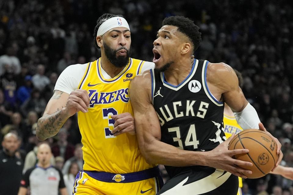 Milwaukee Bucks' Giannis Antetokounmpo tries to drive on Los Angeles Lakers' Anthony Davis during the second overtime of an NBA basketball game Tuesday, March 26, 2024, in Milwaukee. The Lakers won 128-124 in double overtime. (AP Photo/Morry Gash)