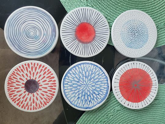 A set of six colorful ceramic coasters