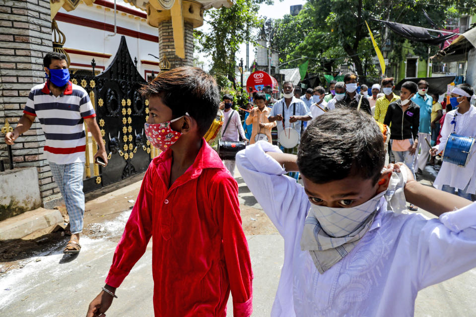 Muslims wearing face masks beat drums as they take part in a Muharram procession in Kolkata, India, Sunday, Aug. 30, 2020. India has the third-highest coronavirus caseload after the United States and Brazil, and the fourth-highest death toll in the world. (AP Photo/Bikas Das)