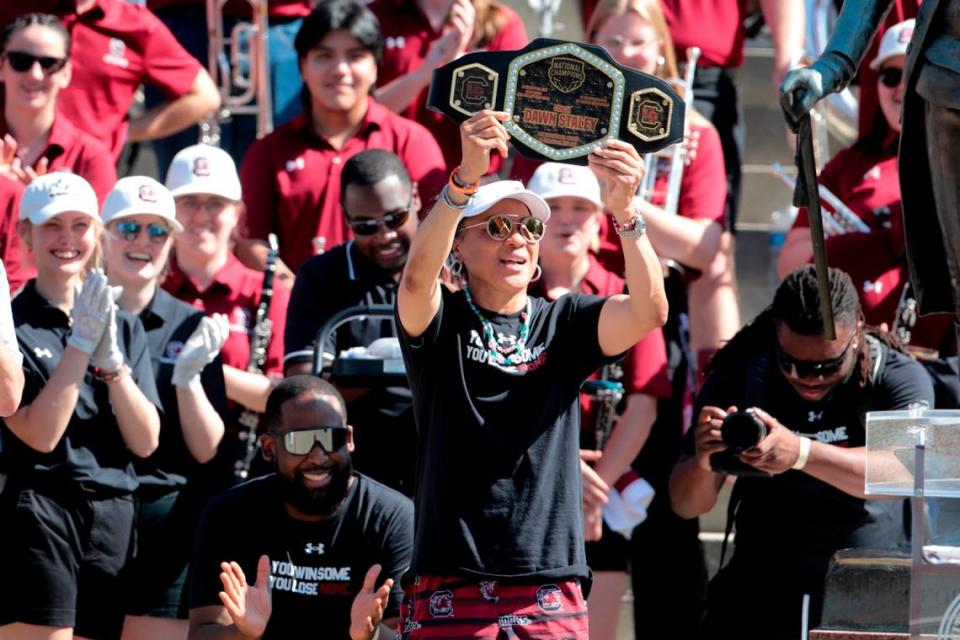 University of South Carolina Head Coach Dawn Staley shows off a belt presented to her by Mayor Daniel Rickenmann after a parade through downtown Columbia and a ceremony at the South Carolina State House on Sunday, April 14, 2024. The Gamecocks women’s basketball team won the the National Championship after having an undefeated season.