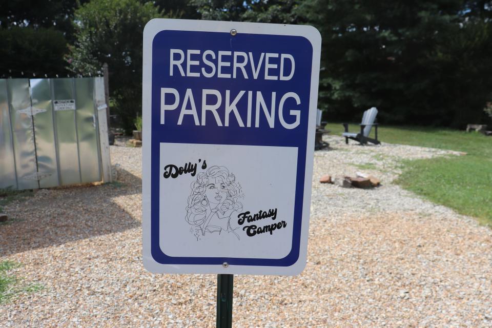 A sign that says "Reserved parking: Dolly's Fantasy Camper"