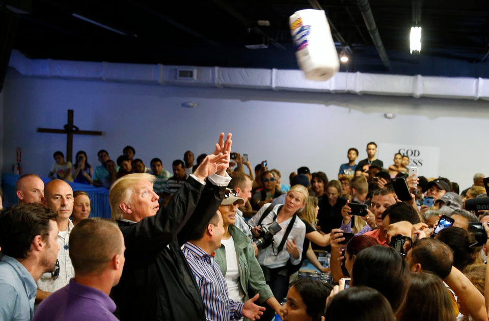 President Trump chucks rolls of paper towels into a crowd of local residents at Calgary Chapel in San Juan on Oct. 3. (Photo: Jonathan Ernst / Reuters)