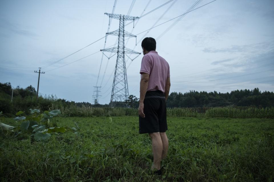 Yu Kongjian stands in a dried-out pond in Xixinan village, Anhui province.