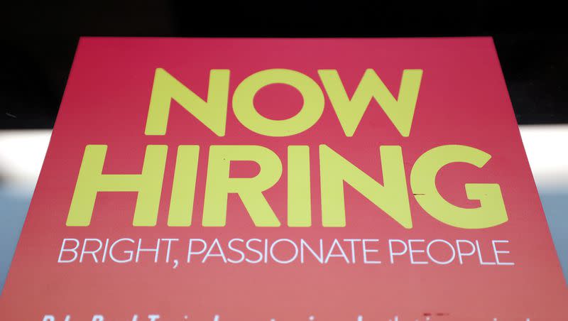 A “Now Hiring” sign is pictured at Palm Beach Tan in Salt Lake City on Friday, Jan. 6, 2023.