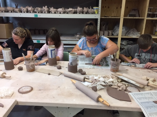 Students work in a pottery class provided through the VSA Kennedy Center program.