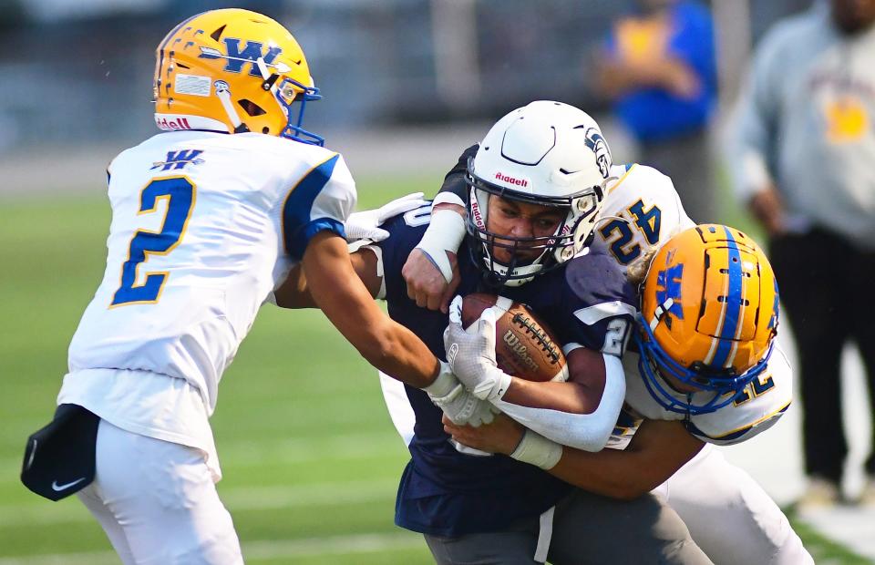 Dayre Senft (20) of Chambersburg is tackled by Wayneboro's Andrew Florek (42).Chambersburg defeated Waynesboro 40-20, Friday, September 8, 2023. (Markell DeLoatch, For GameTimePa)