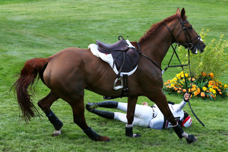 Yoshiaki Oiwa of Japan falls from Noonday de Conde in the Eventing Cross Country Equestrian event on Day 3 of the London 2012 Olympic Games at Greenwich Park on July 30, 2012 in London, England. (Photo by Alex Livesey/Getty Images)