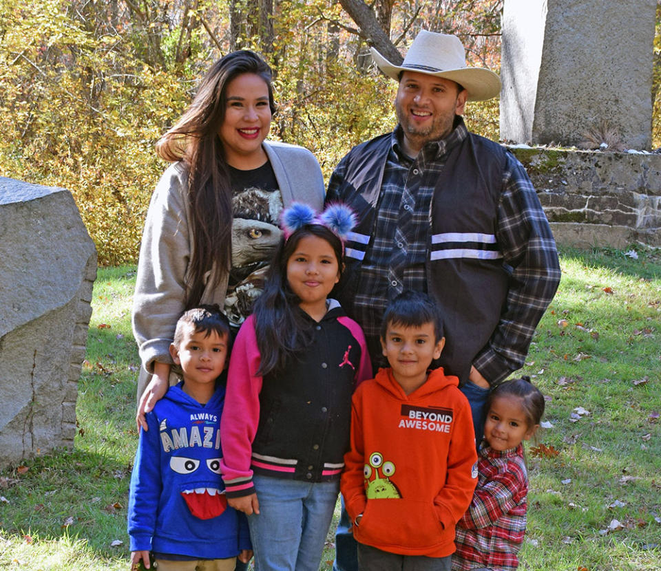 endawnis Spears stands for a family portrait with her children and husband, who is a first councilman for the Narragansett tribe, at a Narragansett tribal event. Her husband, Cassius Spears Jr, is also the nephew of museum leader, educator and former Narragansett Tribal Councilwoman Lorén Spears (Heather Mars)