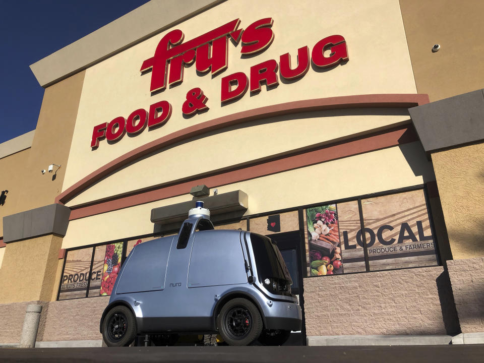 An autonomous vehicle called an R1 created to deliver groceries is displayed outside a Fry's grocery store, which is owned by Kroger Co., in Scottsdale, Ariz., Tuesday, Dec. 18, 2018. The fully autonomous vehicle is set begin piloting public roads Tuesday with no back up driver, though it will be monitored by humans in another automobile. (AP Photo/Brian Skoloff)