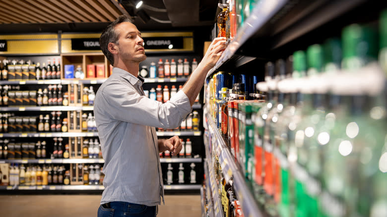 Man browsing liquor store shelves